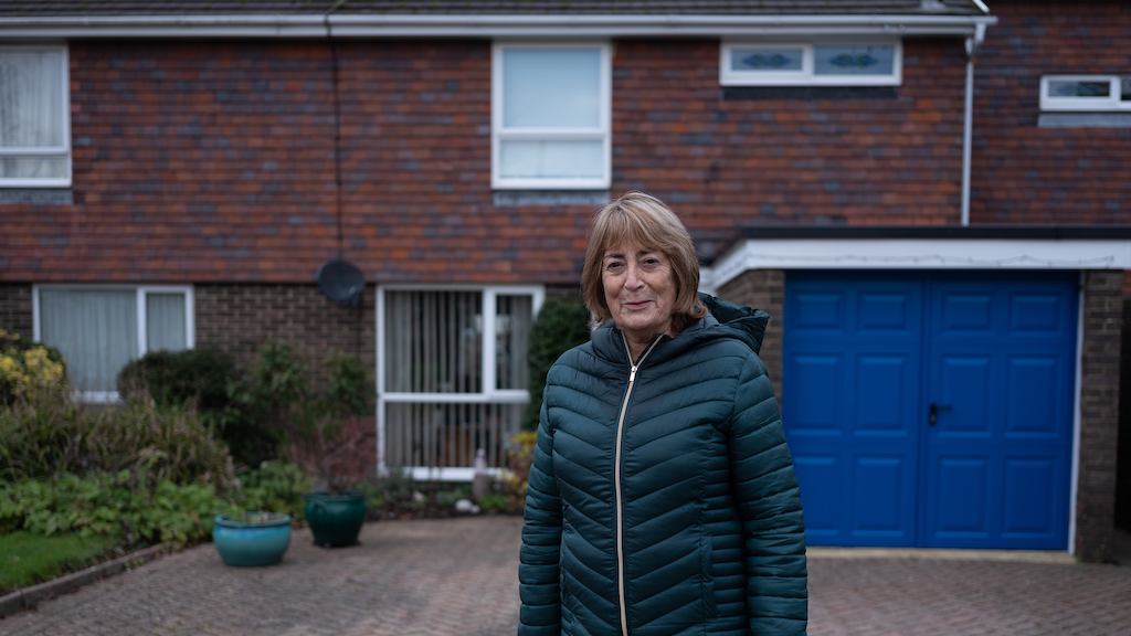 Older-woman-standing-outside-house
